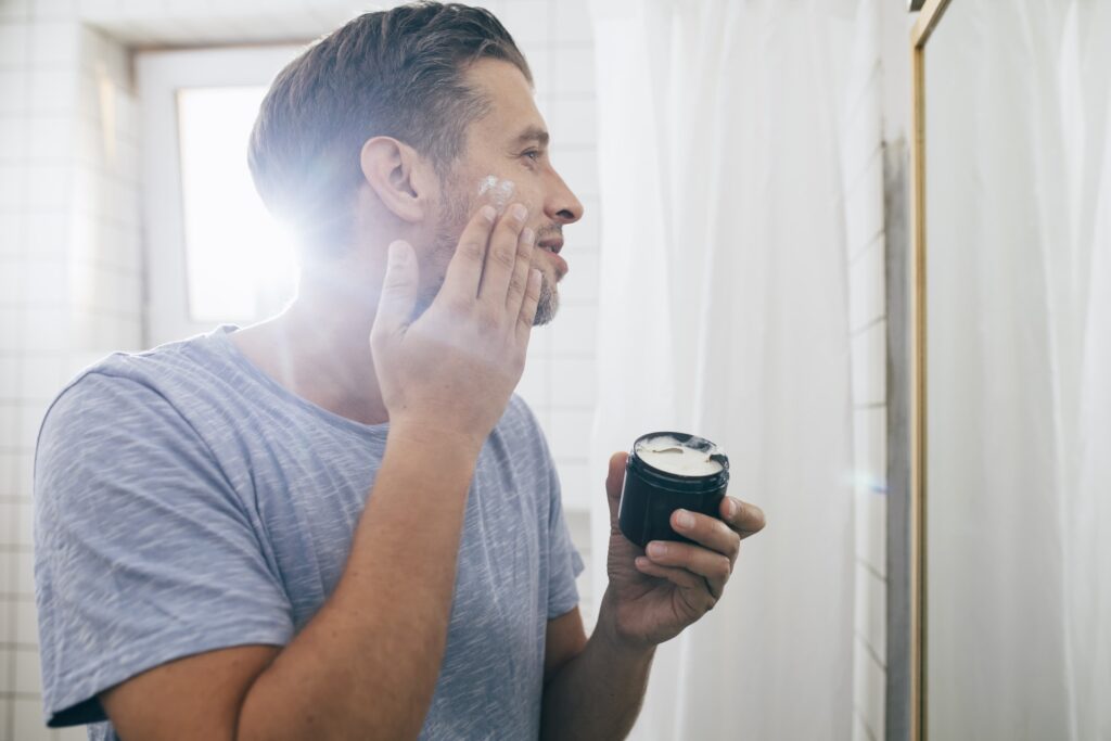 Man applying cream to his face